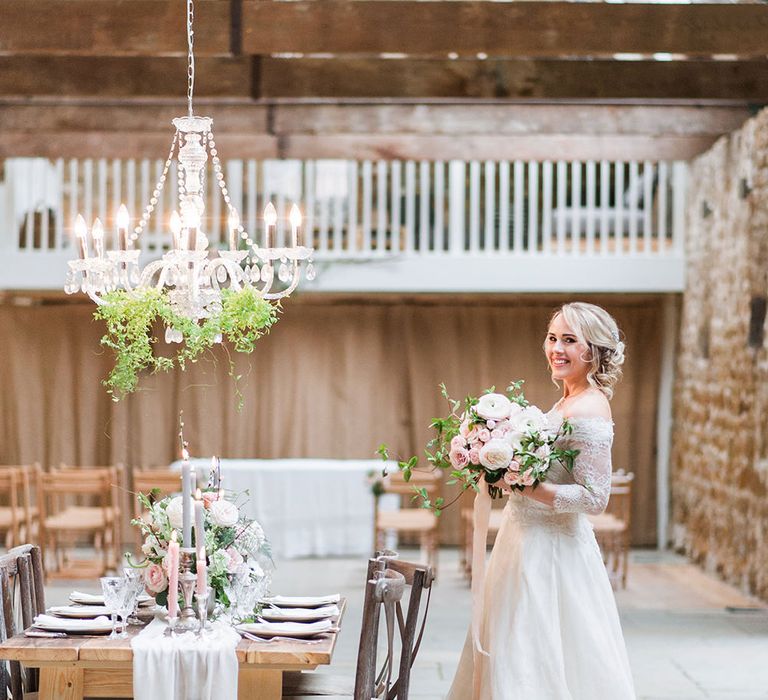 Bride in Lace, Bardot Bridal Gown | Reception Table with Hanging Chandelier | Blush Pink, Romantic, Country Wedding Inspiration at Tithe Barn, Dorset | Darima Frampton Photography