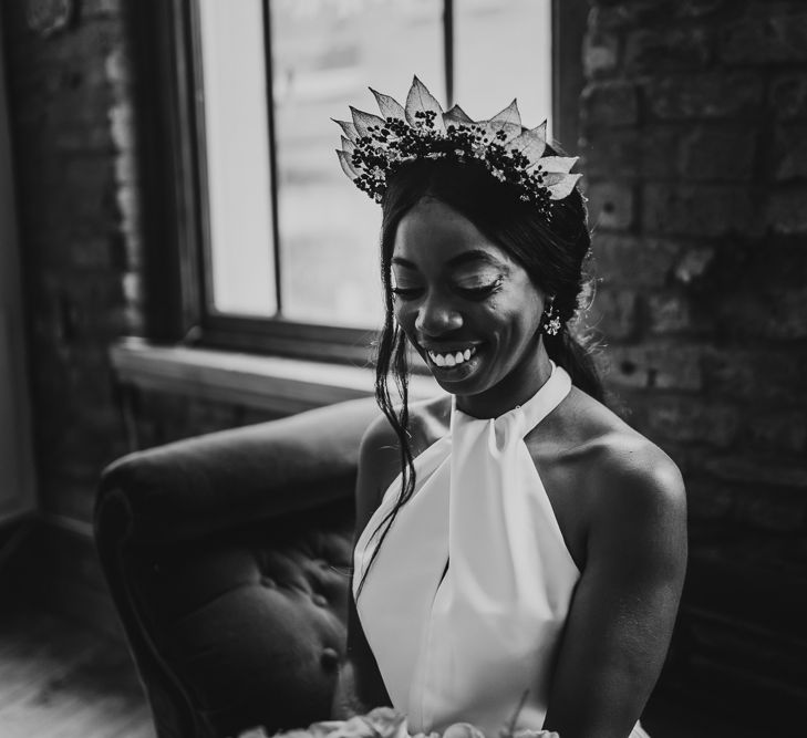 Black and white portrait of bride in halter neck wedding dress and bridal crown