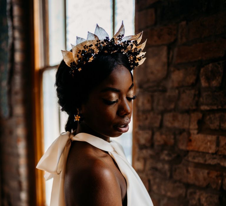 Modern bride in halter neck wedding dress and gold leaf bridal crown