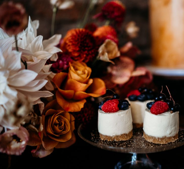 Individual cheesecakes on dessert table