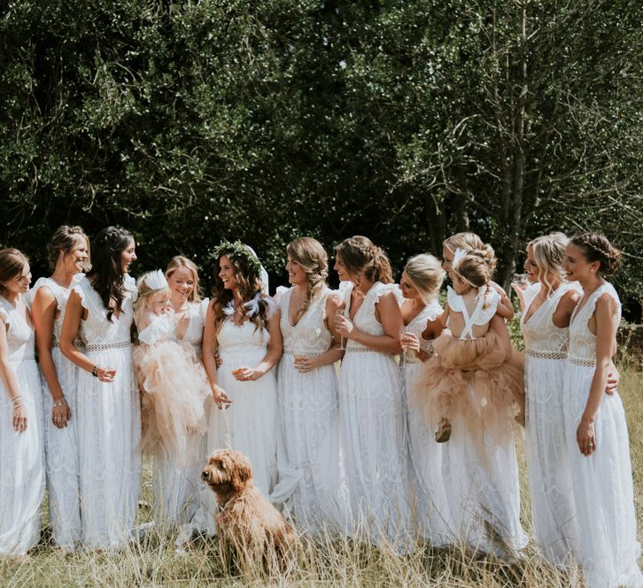 Bridesmaids In White Dresses With Open Backs // Image By Rosie Kelly Photography