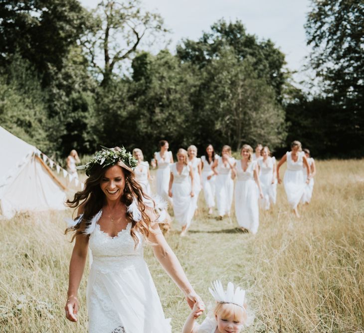 Bridesmaids In White Dresses With Open Backs // Image By Rosie Kelly Photography