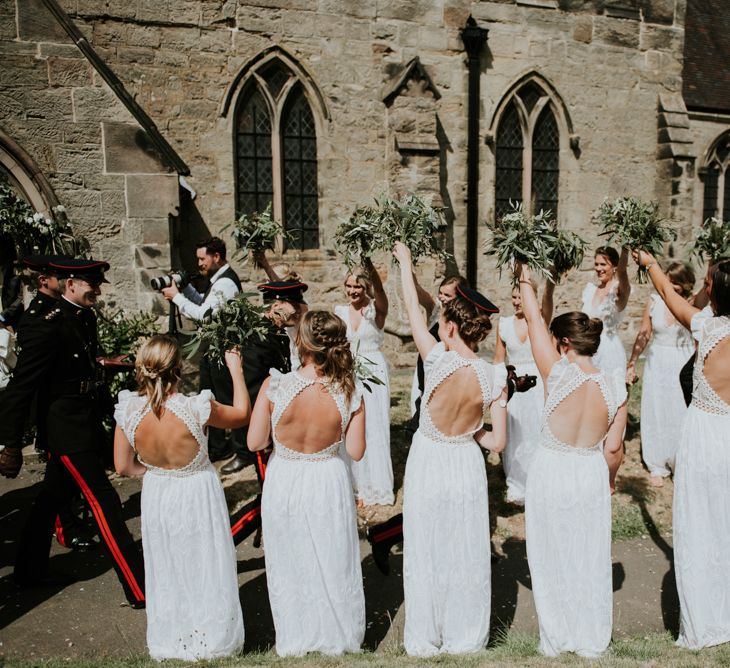 Bridesmaids In White Dresses With Open Backs // Image By Rosie Kelly Photography