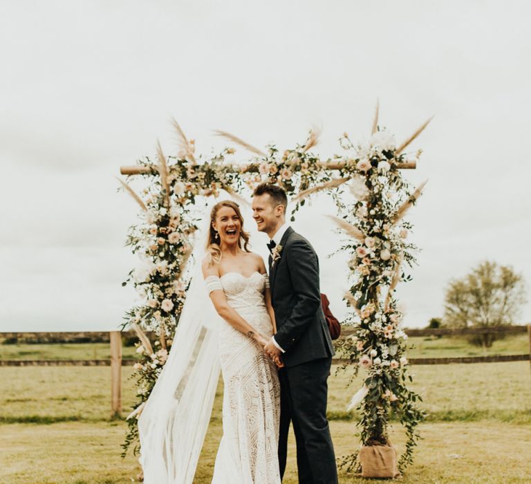 Bride in Sweetheart neckline wedding dress with shoulder detail. . Boho wedding dresses