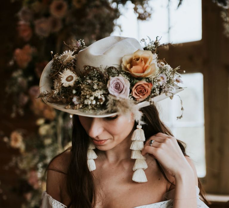 Fedora hat covered in dried flowers and tassel earrings. . Boho wedding dresses