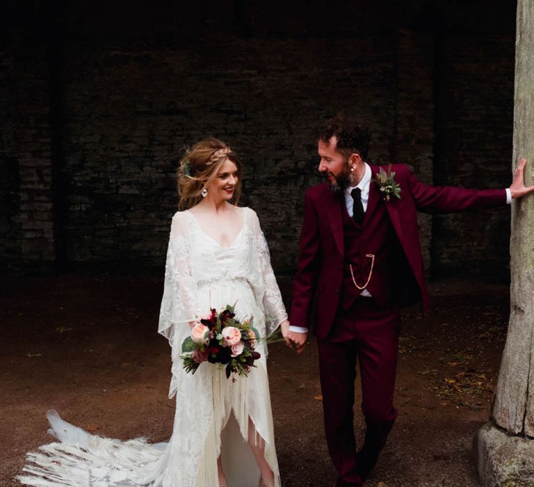 Stylish bride in boho wedding dress with fringe detail