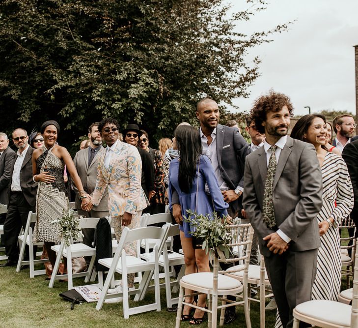 Wedding guests standing at the outdoor wedding for the bridal entrance