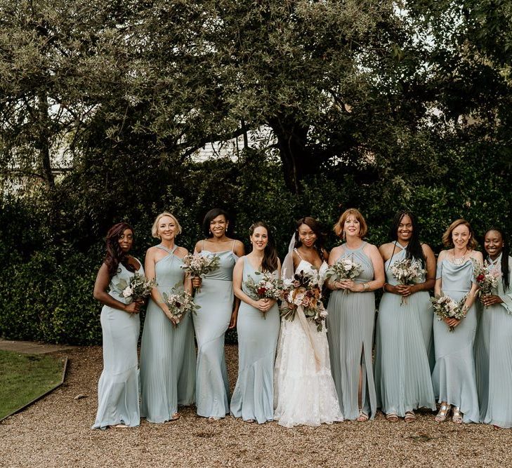 Bridal party portrait with bridesmaid in pale green dresses from Oasis