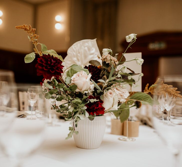 White vase flower centrepiece with roses