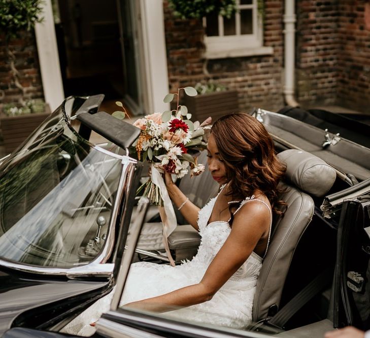 Black Bride in Riki Dalal wedding dress getting into E-Type Jaguar wedding car