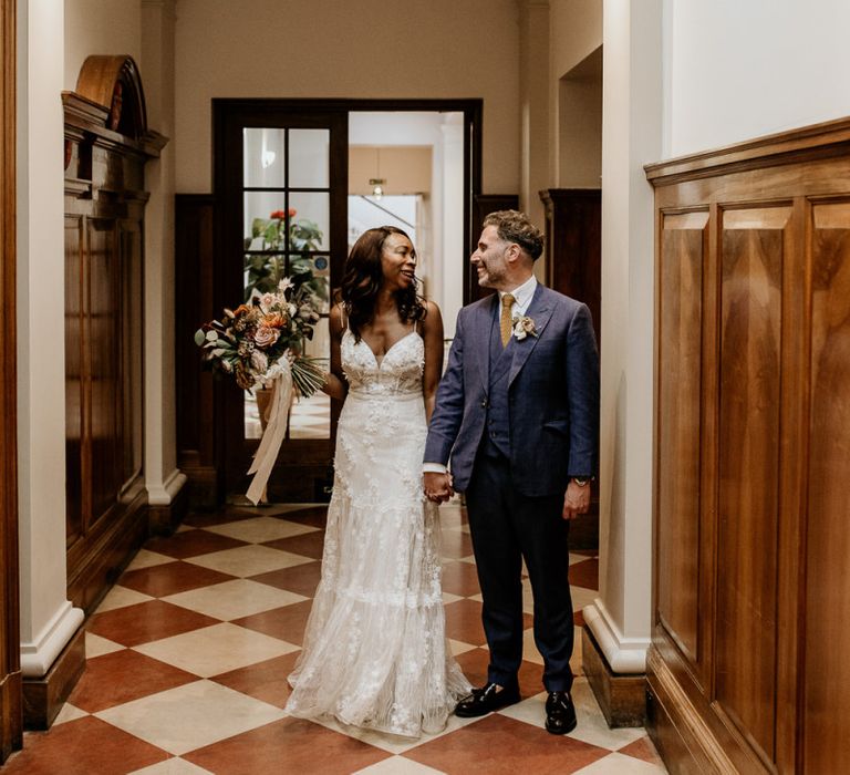 Nigerian bride in Riki Dalal wedding dress and Irish Groom holding hands