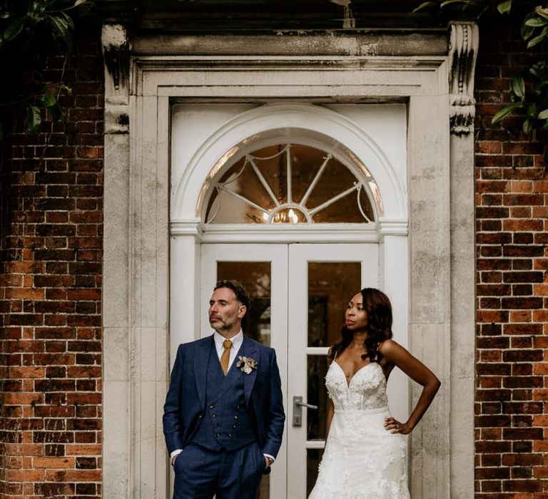 Nigerian bride in Riki Dalal wedding dress and Irish Groom Blue Suit