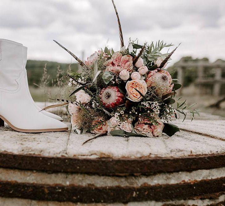 Protea bouquet with white bridal boots