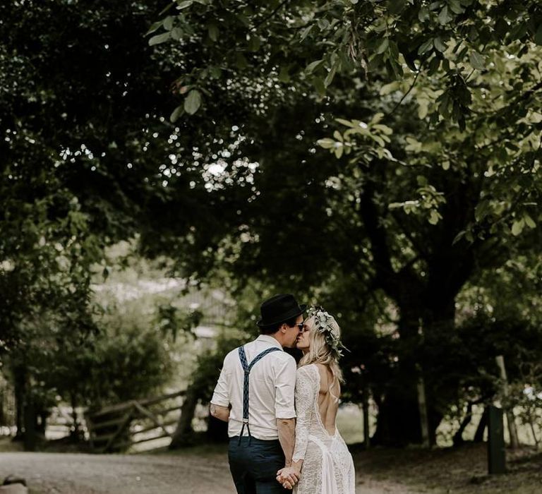 Bride in low back lace wedding dress with Protea bouquet