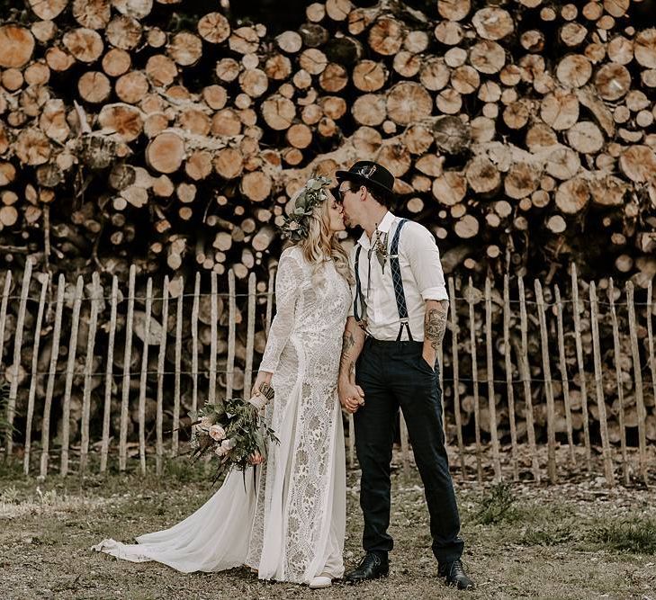 Bride clutches Protea bouquet as she kisses new husband