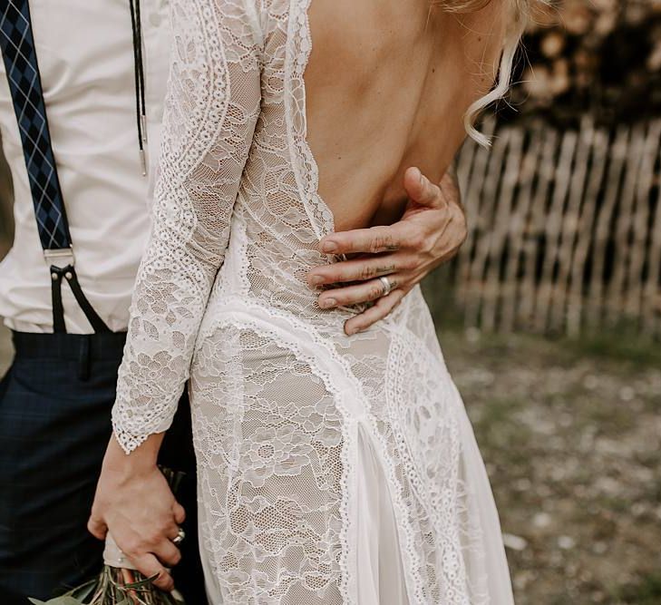 Low back lace detail wedding dress with Protea bouquet