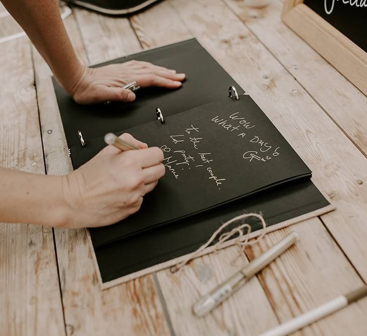 Guests sign the wedding guest book