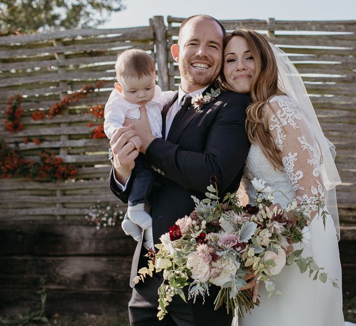 Bride in La Sposa Wedding Dress with Lace Long Sleeves Posing with Wedding Guests