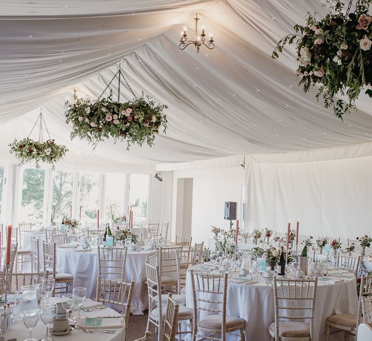 Marquee Wedding Reception with Floral Chandeliers,  Floral Centrepieces and Pink Candles