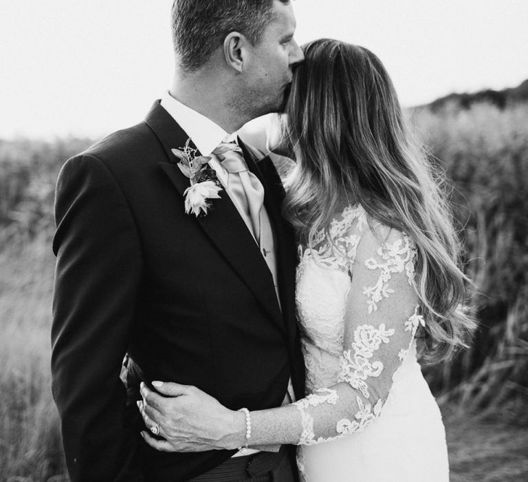 Groom in Traditional Morning Suit Kissing His Brides Forehead