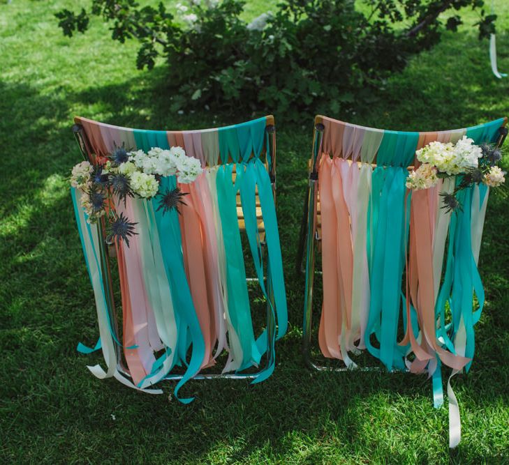 Altar Chairs Decorated with Colourful Ribbons and Flowers