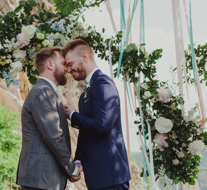 Mr &amp; Mr Embracing in Front of Their Floral Moon Gate