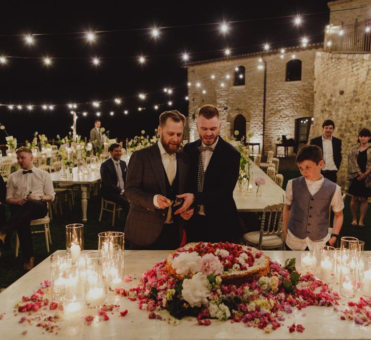 Two Grooms Cutting the Wedding Cake