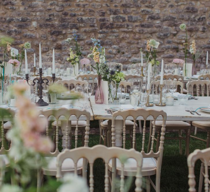 Outdoor Wedding Reception with Pastel Flowers in Vases and Candelabras