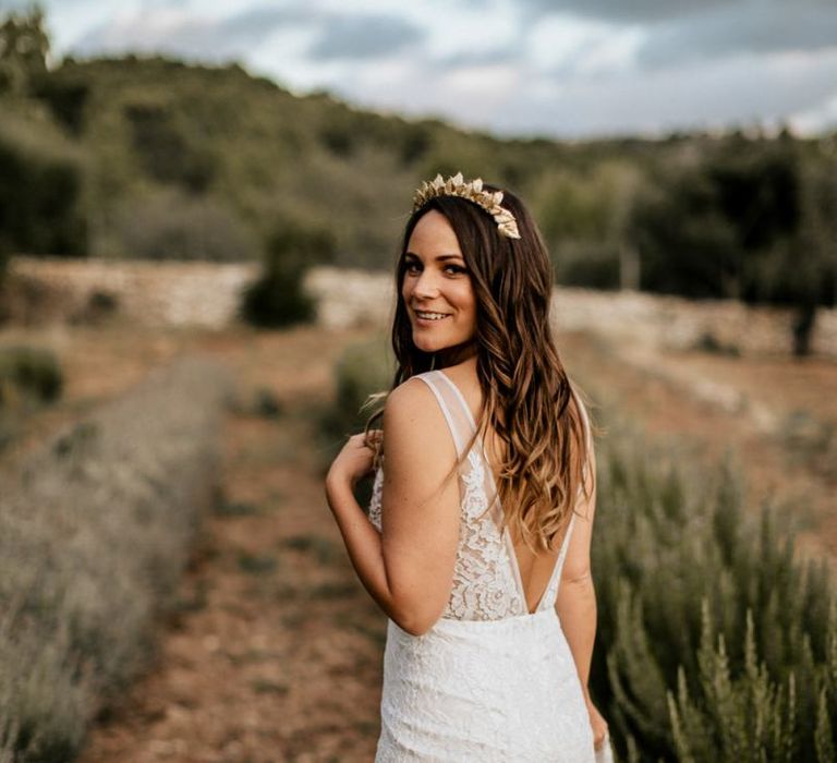 bride with long wavy hair and gold bridal crown