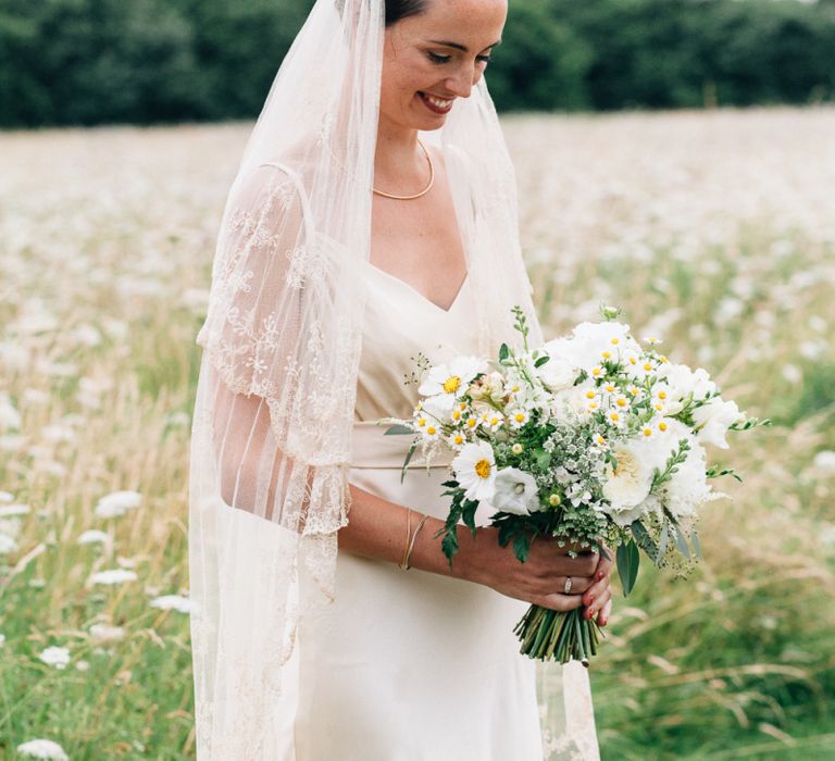 bride in lace veil and gold bridal crown