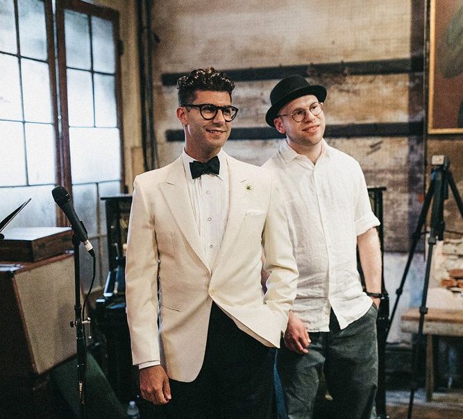 Groom in White Tuxedo Jacket and Bow Tie Standing at the Altar