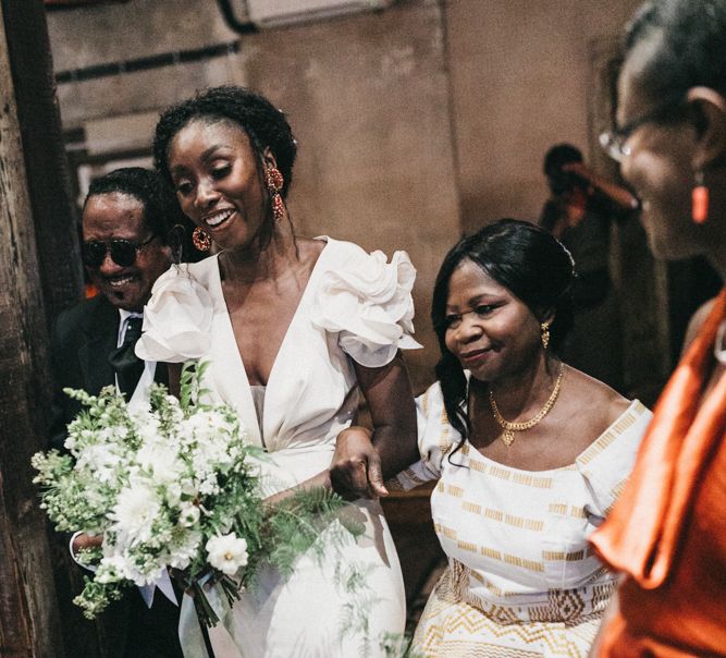 Wedding Ceremony Bridal Entrance in Ruffled Johanna Ortiz Wedding Dress Being Escorted Down The Aisle By Her Mum