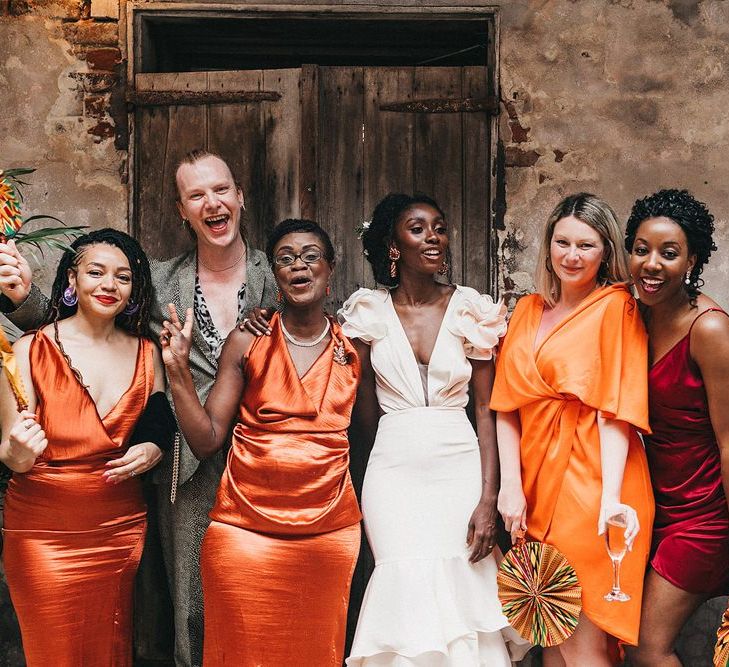 Stylish Bridal Party with Bridesmaids in Different Orange Dresses