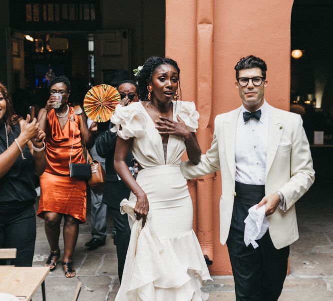 Emotional Bride and Groom as they Enter Their Beautifully Decorated Wedding Reception