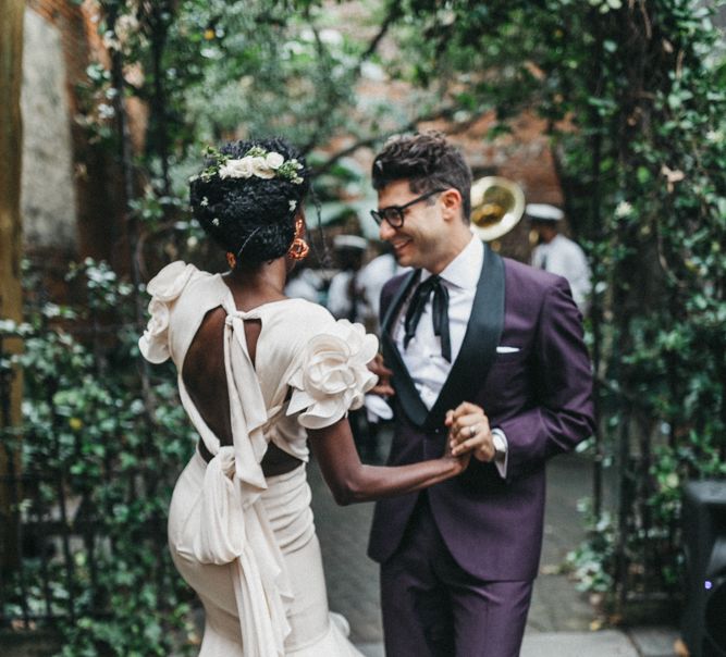 Stylish Bride in Ruffled Johanna Ortiz Wedding Dress and Groom in Burgundy Tuxedo  Dancing