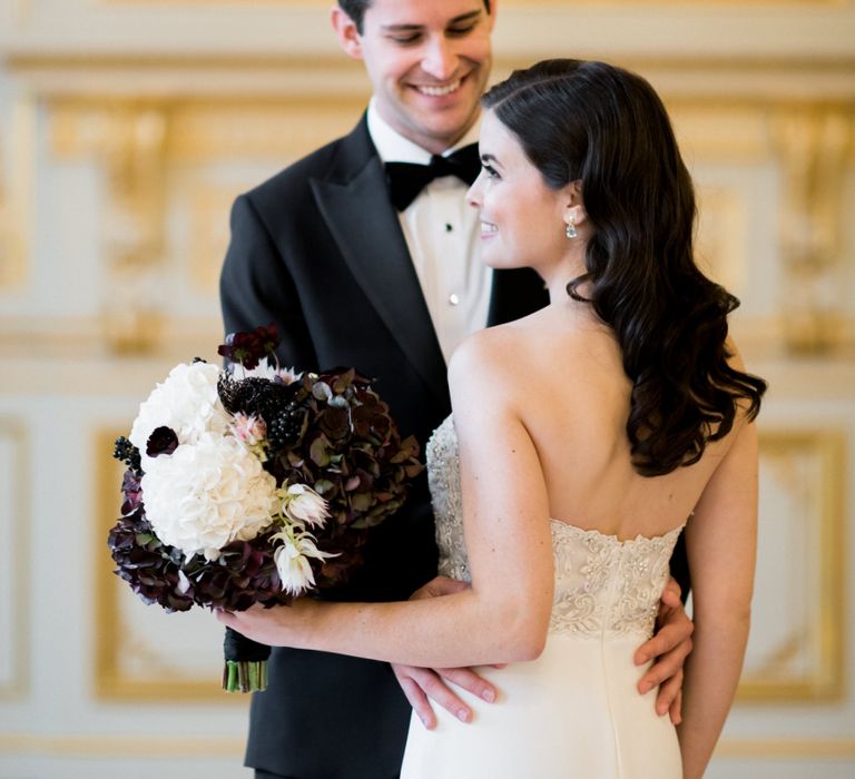 Groom Holding His Brides Waist in an Off The Shoulder Wedding Dress