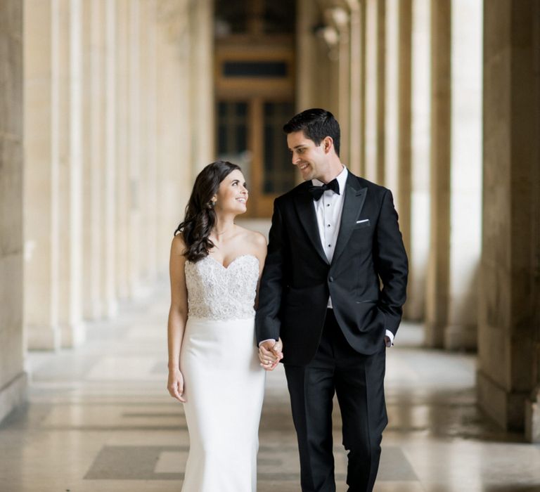 Bride in Tara Keely Wedding Dress and Groom in Black Tie Suit Walking Hand in Hand