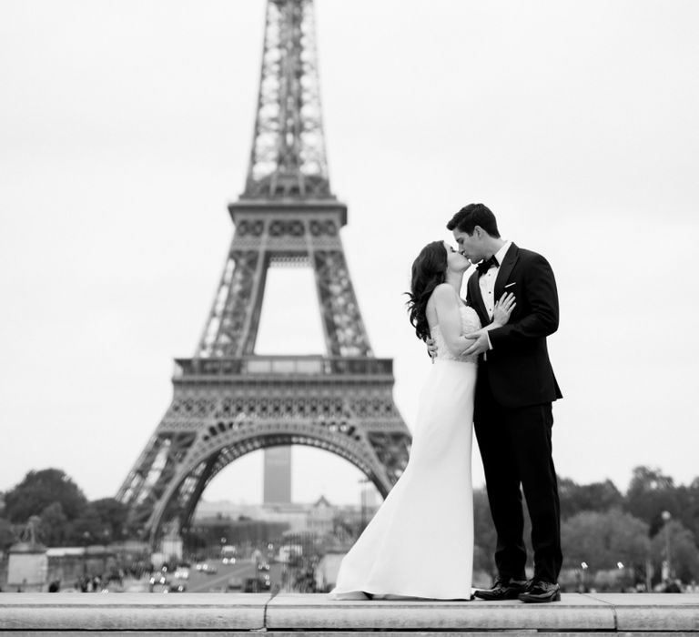 Bride in Tara Keely Wedding Dress and Groom in Black Tie Suit  Standing in Front of the Eiffel Tower