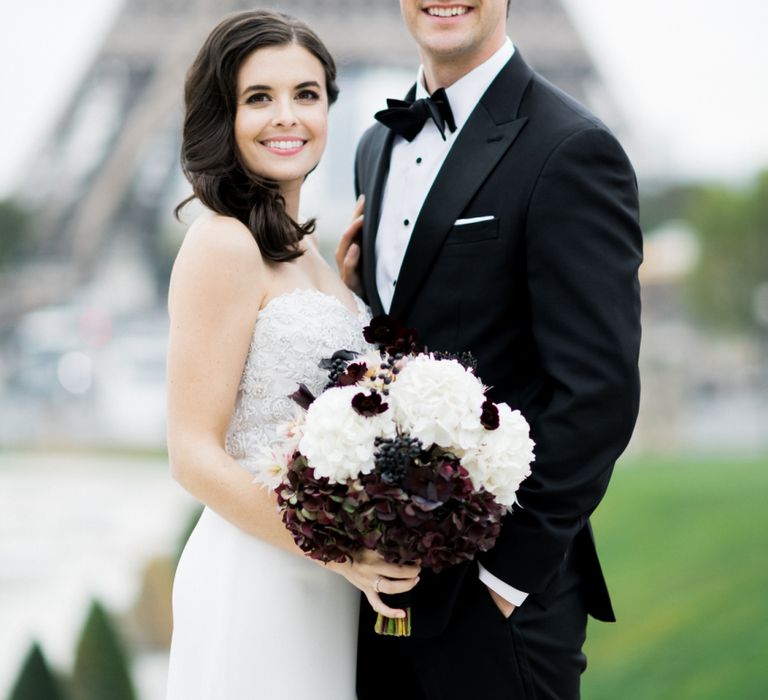 Glamorous Bride in Tara Keely Wedding Dress with Black and White Wedding Bouquet and Groom in Black Tie Suit