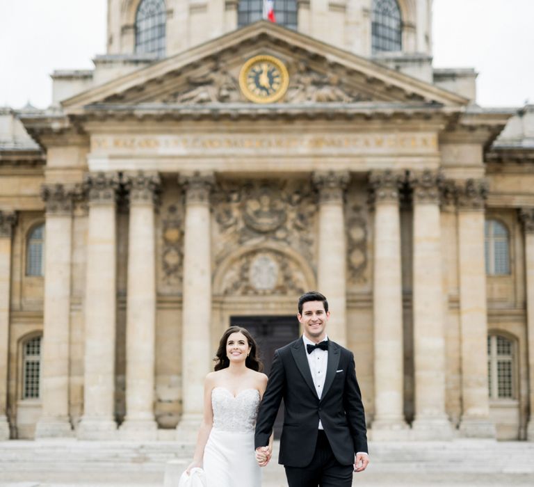 Bride in Off the Shoulder Tara Keely Wedding Dress and Groom in Black Tuxedo Walking the Streets of Paris