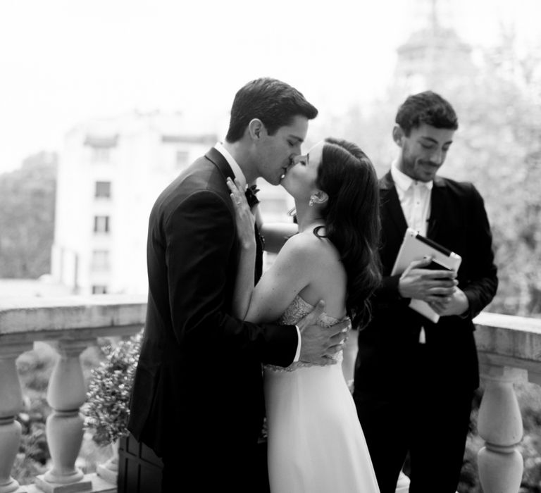 Bride and Groom Kissing after their Paris Rooftop Wedding Ceremony