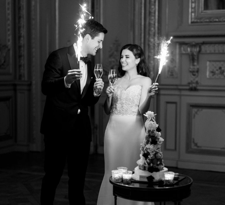 Bride and Groom Holding Cake Sparklers