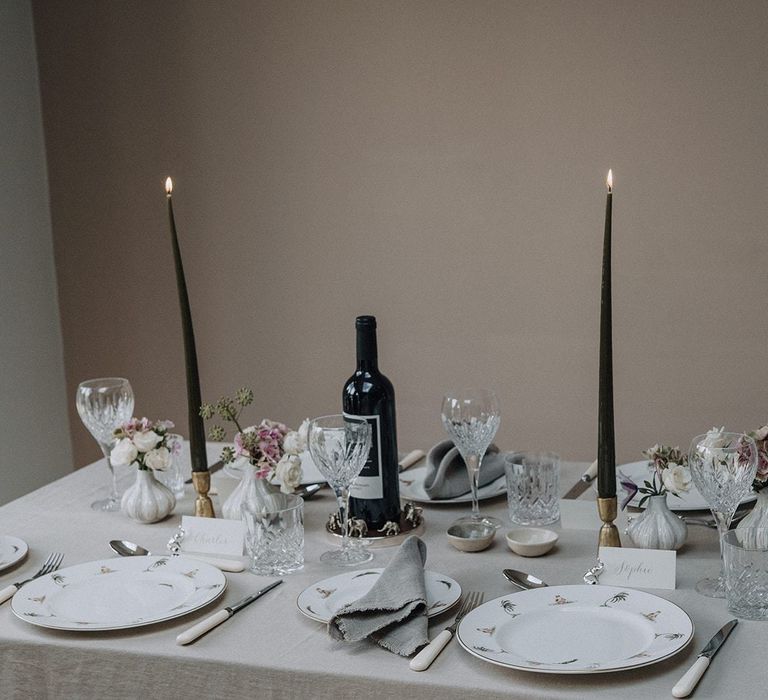 Fine china tableware and serving bowl, with gold candlestick and cut glass crystal glasses