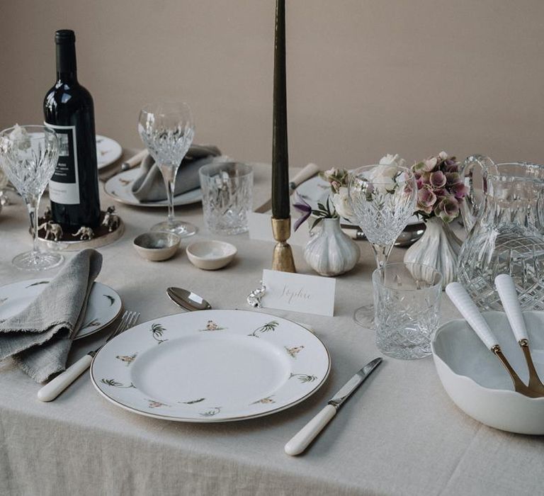 Fine china tableware with taper candles and bud vases