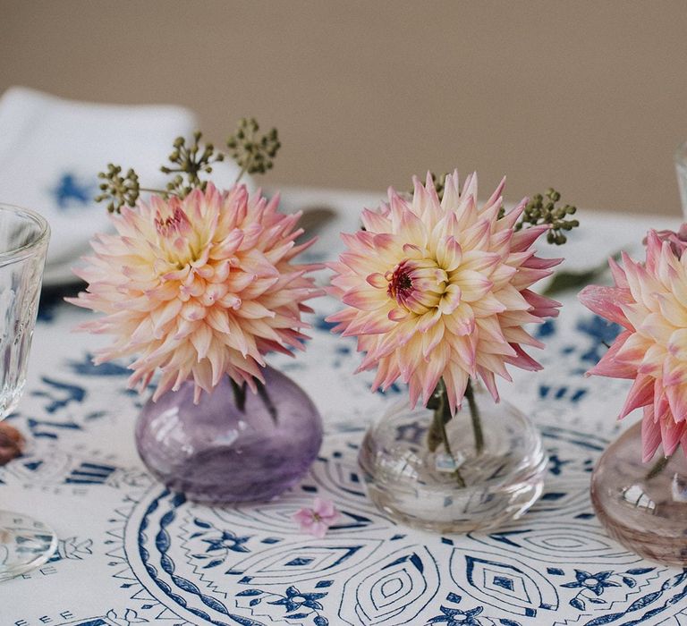 coloured bud vases with flower stems