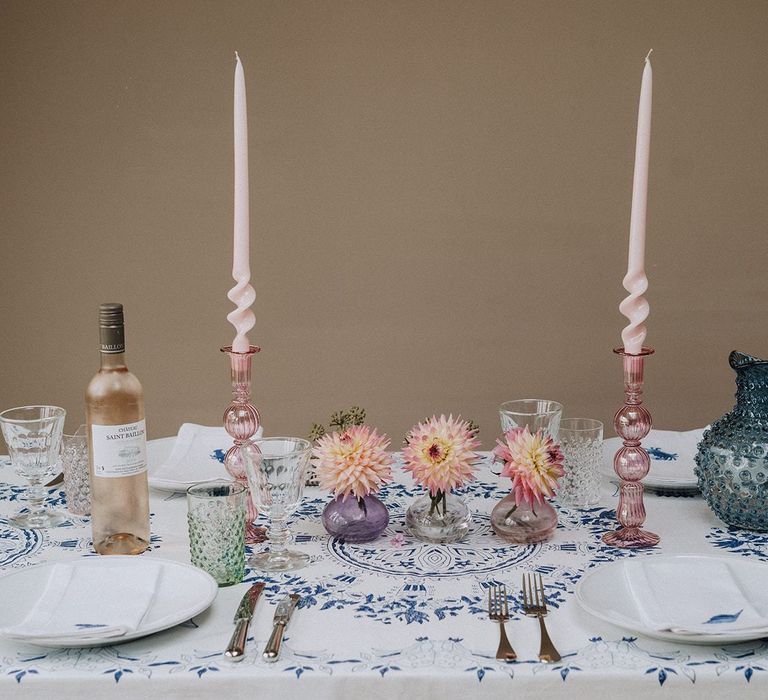 Colourful tablescape with printed linens and glass tableware