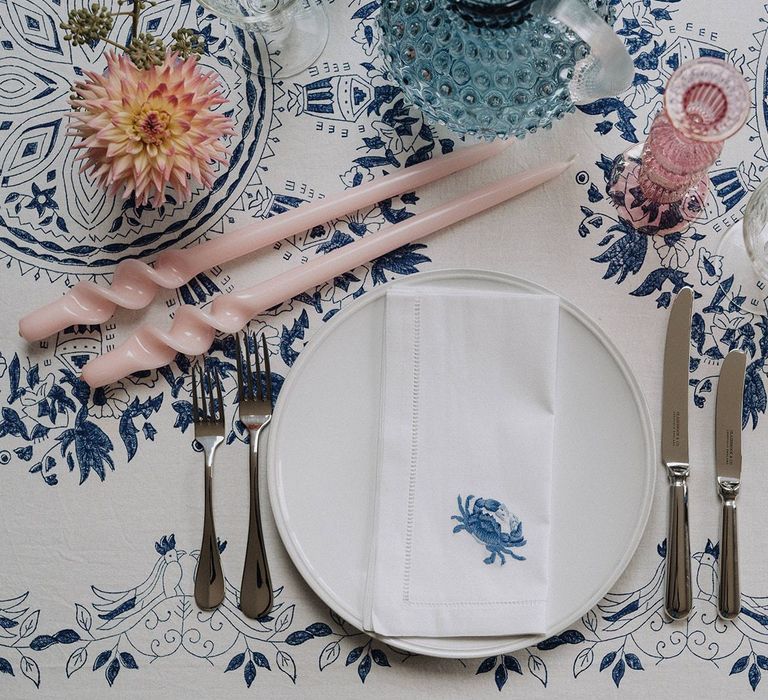 printed table cloth and napkin with coloured glassware