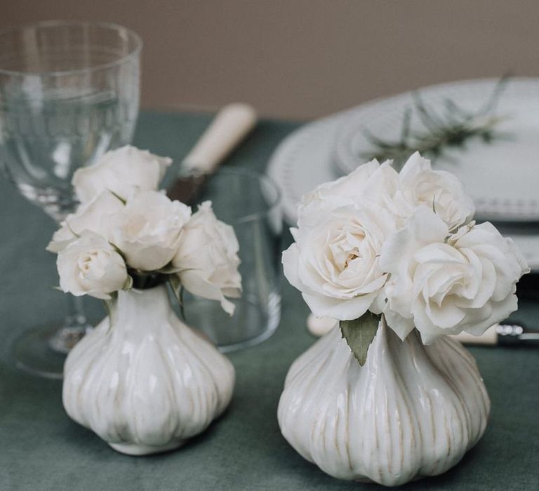 Ceramic bud vases filled with white flower stems