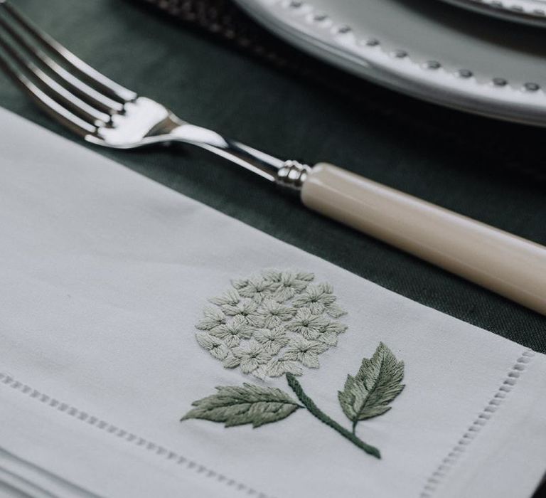 embroidered table linen and ivory cutlery