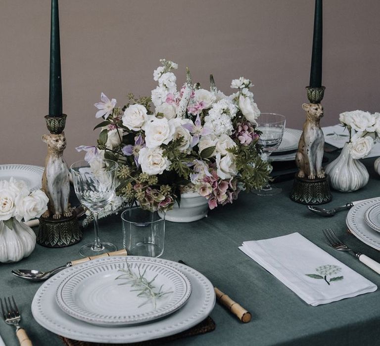 Floral centrepiece and taper candles for elegant tablescape